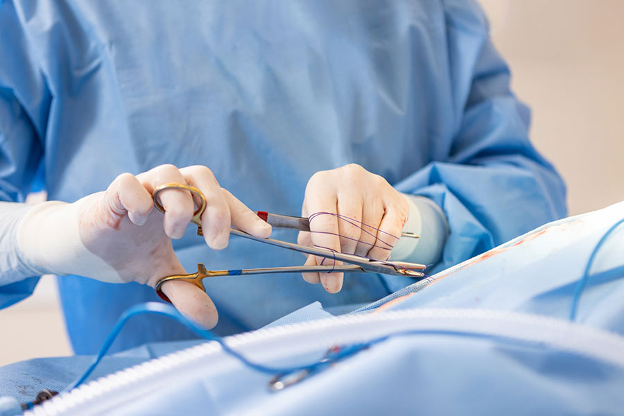 closeup of doctor's hands while performing surgery